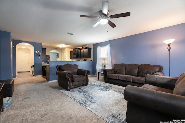 carpeted living room featuring ceiling fan