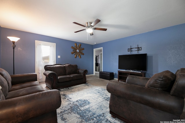 carpeted living room with ceiling fan