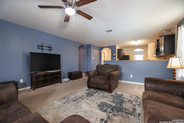 carpeted living room with ceiling fan