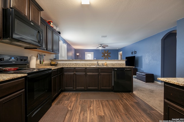 kitchen featuring kitchen peninsula, dark hardwood / wood-style flooring, black appliances, and ceiling fan