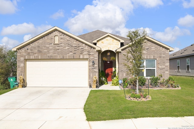 view of front of home featuring a garage and a front yard