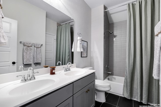 full bathroom featuring tile patterned floors, shower / bath combination with curtain, toilet, and vanity