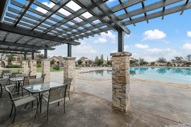 view of patio / terrace with a pergola and a community pool