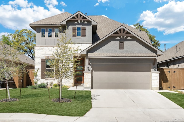 view of front of house with a garage and a front lawn