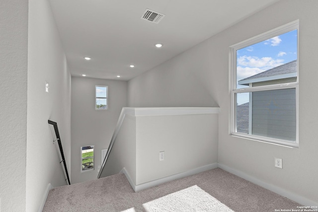 stairs featuring carpet flooring and plenty of natural light