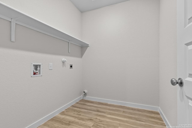 washroom featuring hookup for an electric dryer, hookup for a washing machine, light hardwood / wood-style floors, and hookup for a gas dryer