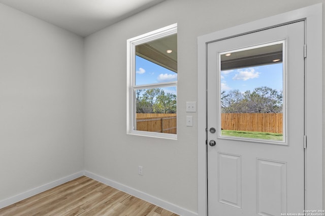 doorway to outside with light wood-type flooring