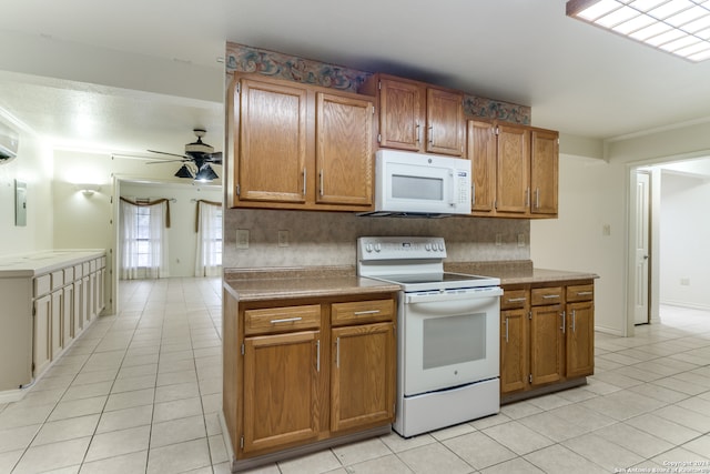 kitchen featuring ceiling fan, backsplash, white appliances, light tile patterned floors, and ornamental molding