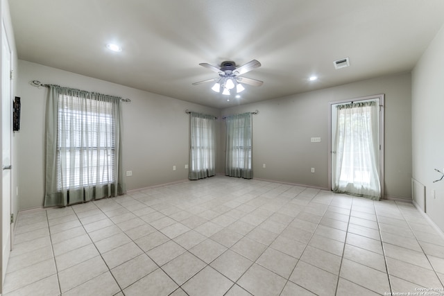 unfurnished room with ceiling fan, plenty of natural light, and light tile patterned floors