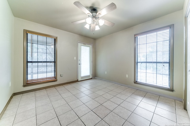 spare room featuring ceiling fan and light tile patterned flooring