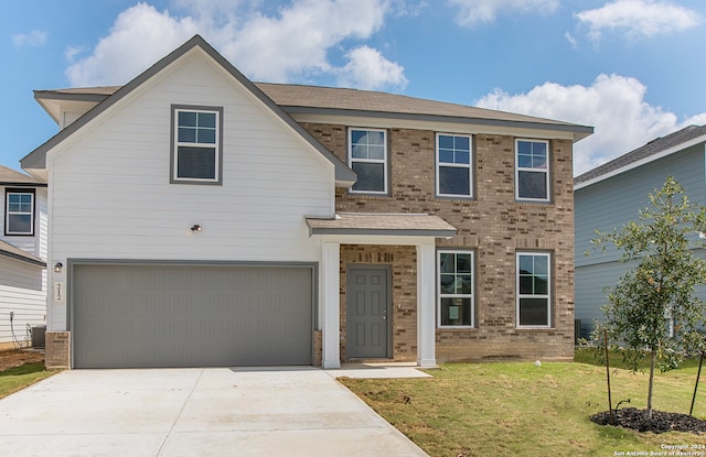 view of front facade featuring a garage, central AC, and a front yard