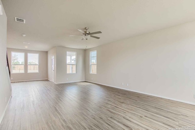 spare room with light wood-type flooring and ceiling fan