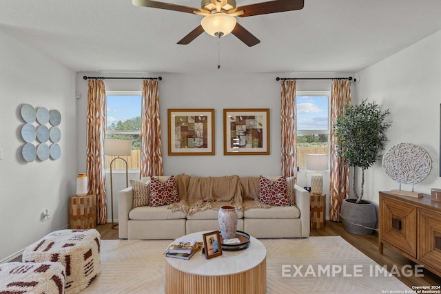 living room featuring ceiling fan and light hardwood / wood-style flooring