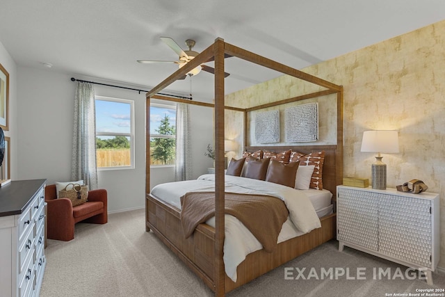 bedroom with ceiling fan and light carpet