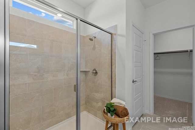 bathroom with tile patterned flooring and an enclosed shower