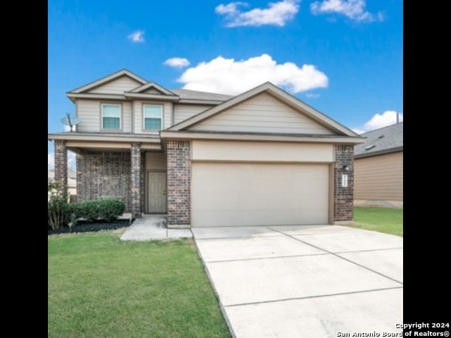 view of front of property with a garage and a front yard