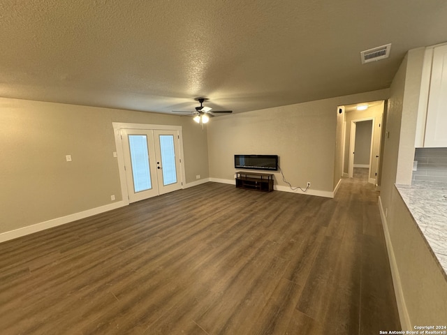 unfurnished living room featuring a textured ceiling, ceiling fan, french doors, and dark hardwood / wood-style floors