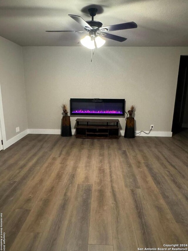 sitting room featuring ceiling fan and dark hardwood / wood-style flooring