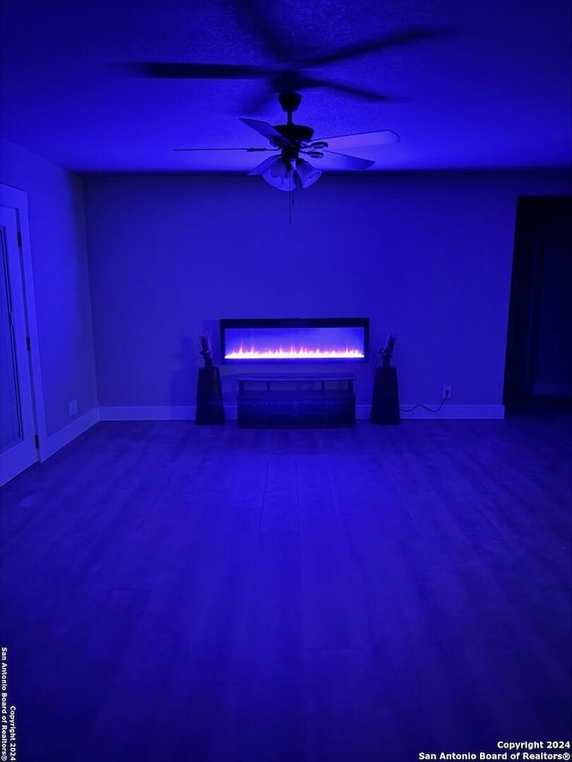 unfurnished living room featuring ceiling fan and wood-type flooring