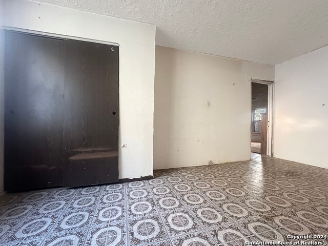 empty room with a textured ceiling