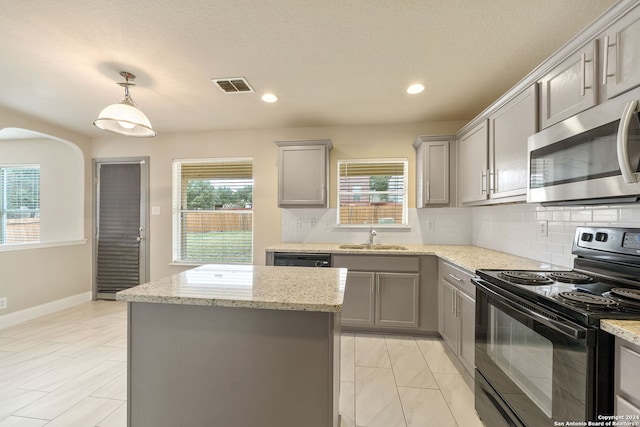 kitchen featuring decorative backsplash, appliances with stainless steel finishes, sink, and plenty of natural light