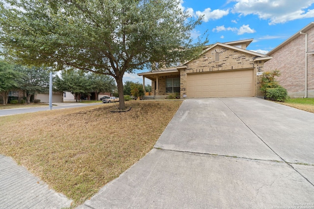 ranch-style home featuring a garage and a front lawn