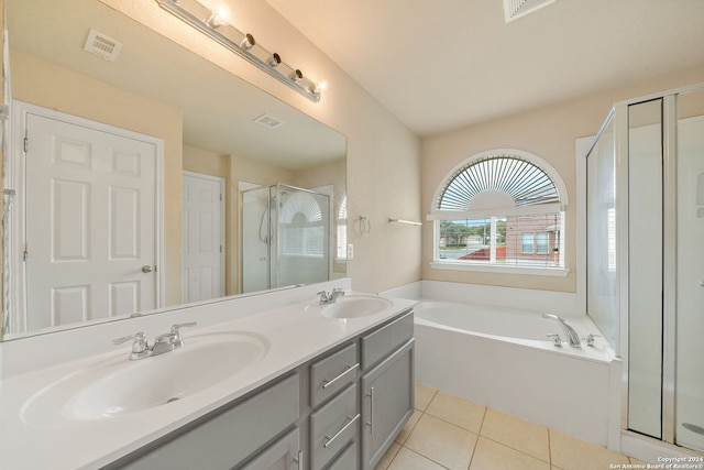 bathroom with independent shower and bath, vanity, and tile patterned floors