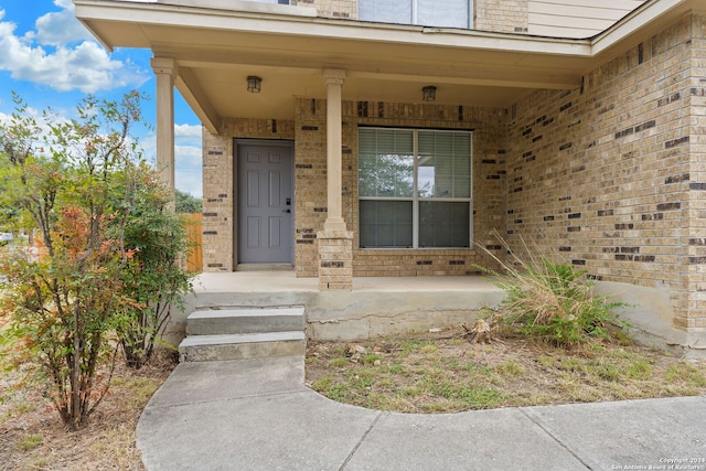 entrance to property featuring a porch