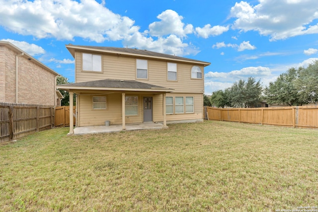 back of property with a patio and a yard