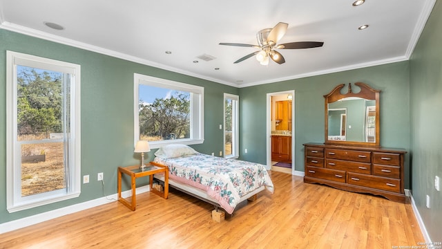 bedroom featuring crown molding, ensuite bath, light hardwood / wood-style floors, and ceiling fan