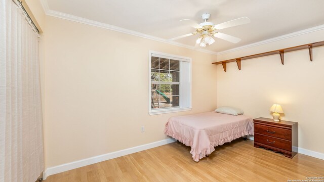 bedroom with ornamental molding, ceiling fan, and light hardwood / wood-style flooring