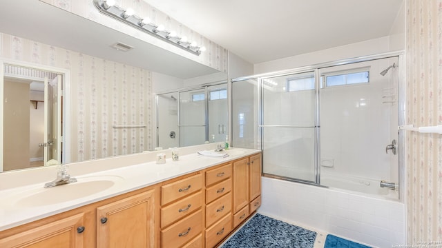 bathroom featuring bath / shower combo with glass door, vanity, and tile patterned floors