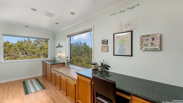 interior space featuring ornamental molding and light hardwood / wood-style flooring