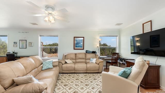 living room featuring ceiling fan, light hardwood / wood-style flooring, and ornamental molding