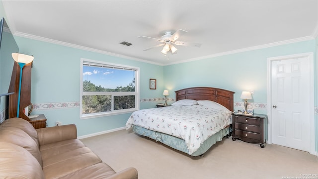 carpeted bedroom featuring ceiling fan and ornamental molding