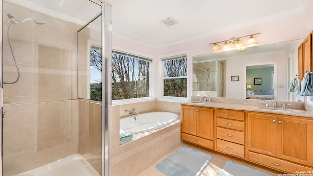 bathroom featuring ornamental molding, shower with separate bathtub, and vanity