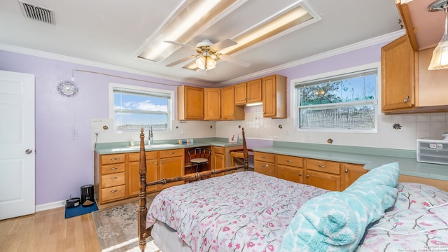 kitchen featuring sink, tasteful backsplash, ornamental molding, ceiling fan, and light hardwood / wood-style flooring