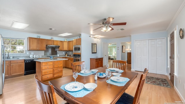 dining space with ceiling fan, sink, light wood-type flooring, and ornamental molding