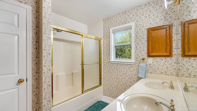 bathroom featuring vanity and shower / bath combination with glass door