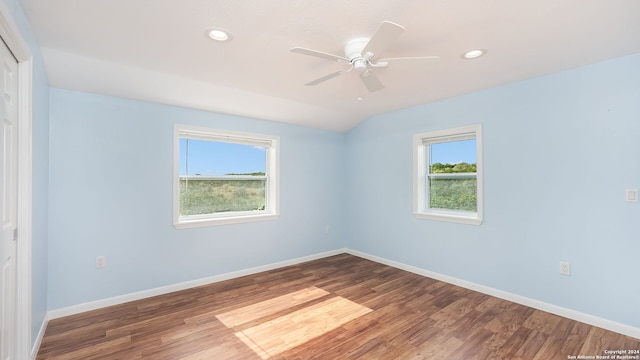 unfurnished room featuring a wealth of natural light, hardwood / wood-style floors, and ceiling fan