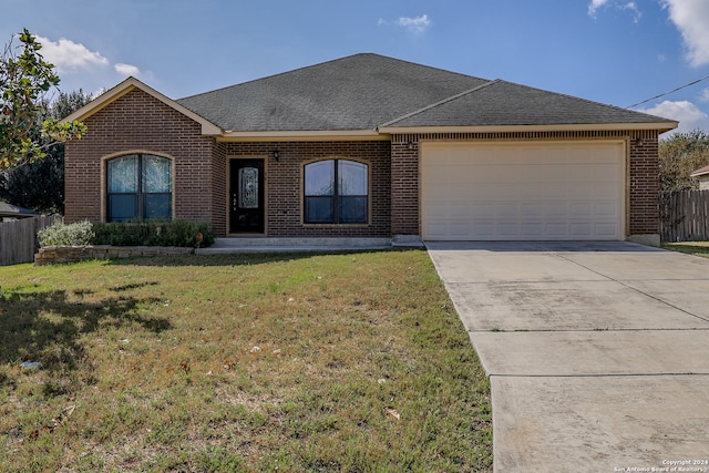 ranch-style home with a garage and a front lawn