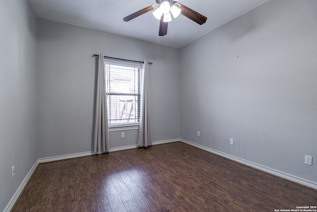 empty room featuring ceiling fan and dark hardwood / wood-style flooring