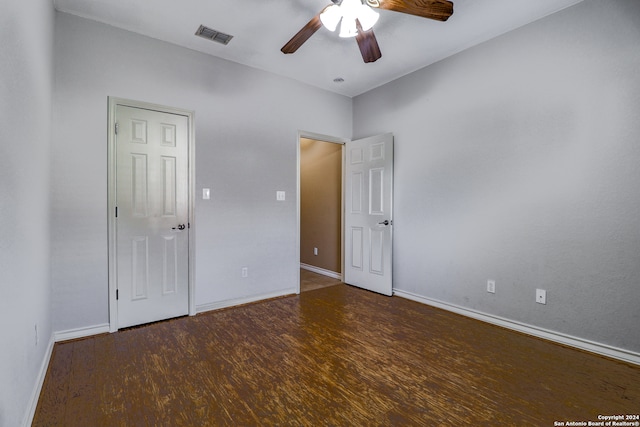 unfurnished bedroom with dark wood-type flooring and ceiling fan