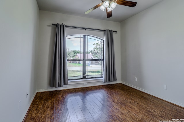 empty room with dark wood-type flooring and ceiling fan