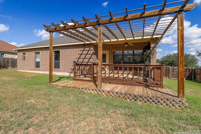 exterior space with a pergola, a lawn, and a wooden deck