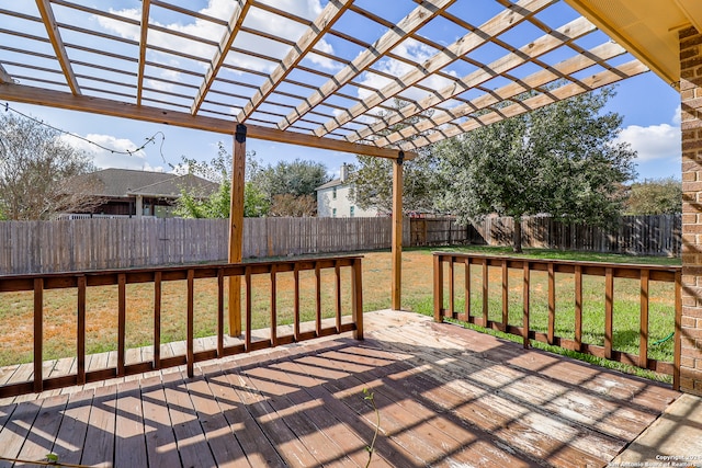 deck with a pergola and a lawn