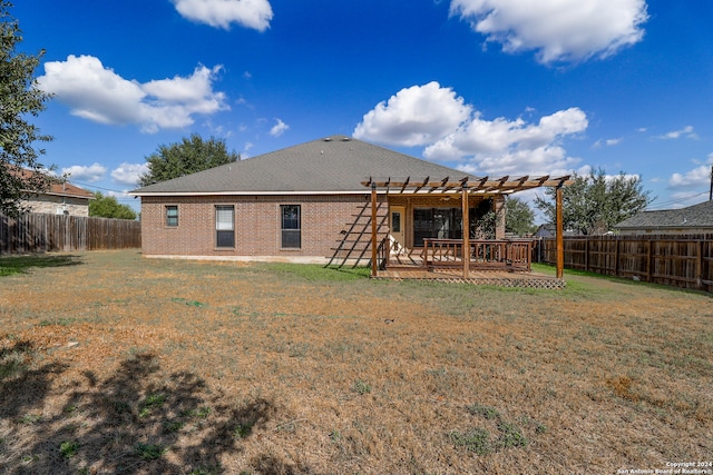 back of property with a yard, a pergola, and a patio area