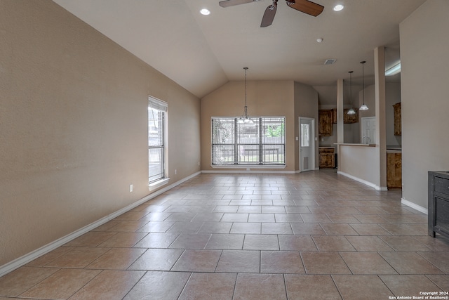 unfurnished living room featuring ceiling fan with notable chandelier, light tile patterned floors, and vaulted ceiling