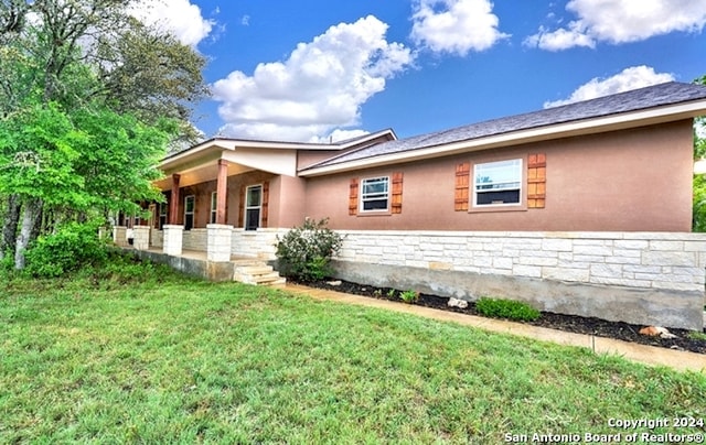 view of side of property with a yard