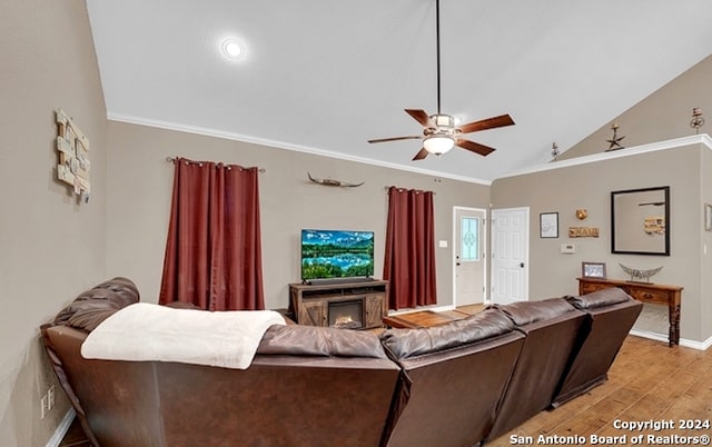 living room featuring ornamental molding, high vaulted ceiling, ceiling fan, a fireplace, and light hardwood / wood-style flooring